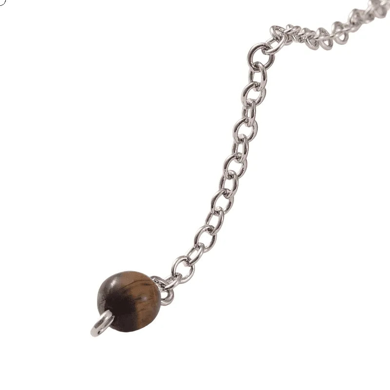 Tigers eye faceted cone pendulum detail showing golden crystal for strength divination and courage from The Witches Hollow UK