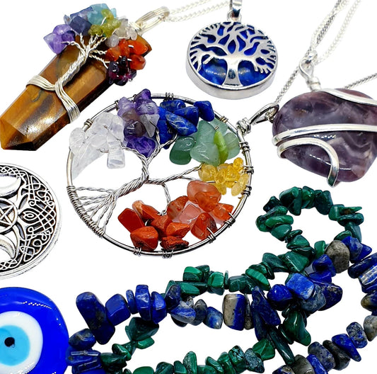 Crystal healing jewelry collection featuring chakra tree of life pendants, amethyst wire wrapped stones, malachite chip bracelets and protective amulets for metaphysical cleansing UK