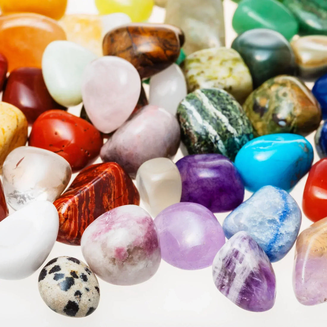 Diverse collection of tumbled healing crystals including amethyst, rose quartz, citrine, green aventurine and jasper stones - mystical powers of crystals for spiritual healing and metaphysical practices UK