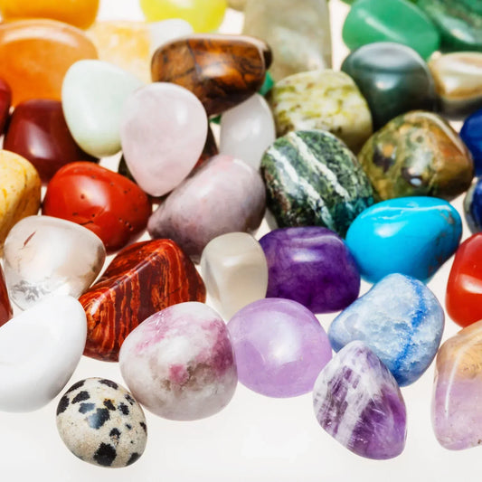 Diverse collection of tumbled healing crystals including amethyst, rose quartz, citrine, green aventurine and jasper stones - mystical powers of crystals for spiritual healing and metaphysical practices UK