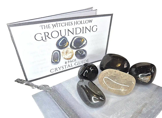 Grounding crystal healing pack with hematite, black tourmaline, smoky quartz stones in silver organza bag with crystal guide from The Witches Hollow UK