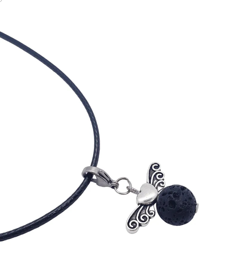 Lava stone angel charm detail showing volcanic stone angel for spiritual protection and aromatherapy from The Witches Hollow UK