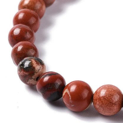 Red aventurine crystal bracelet detail showing red stones for motivation and confidence from The Witches Hollow UK