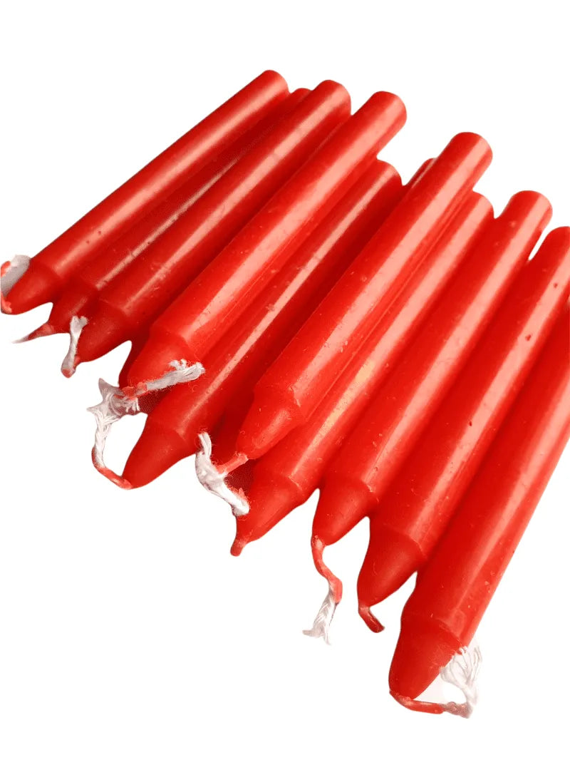 Red spell candle with red wax for passion and root chakra magic from The Witches Hollow UK