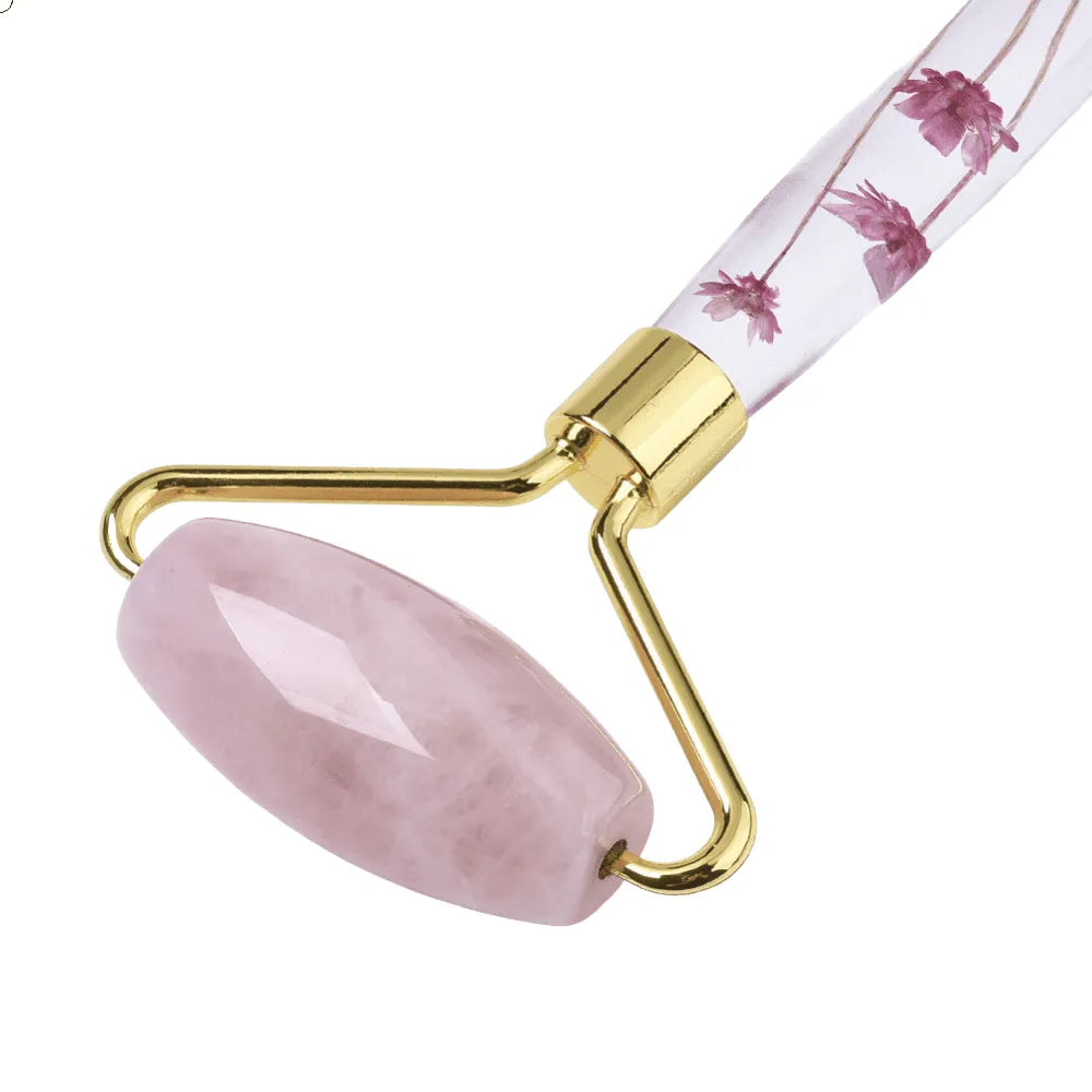 Rose quartz crystal facial roller detail showing pink stone tool for facial massage and heart chakra from The Witches Hollow UK