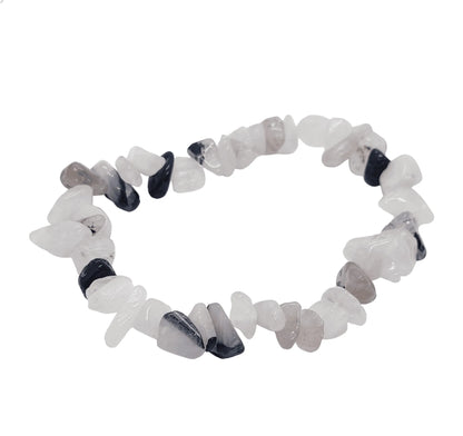 Rutilated quartz crystal bracelet detail showing clear stone with golden threads for manifestation from The Witches Hollow UK