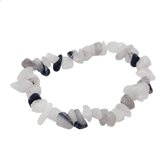 Rutilated quartz crystal bracelet detail showing clear stone with golden threads for manifestation from The Witches Hollow UK