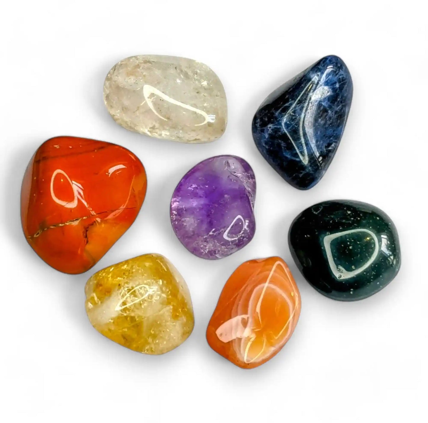 Seven chakra crystal stones set featuring amethyst, sodalite, green aventurine, carnelian, citrine, clear quartz and red jasper for healing and meditation